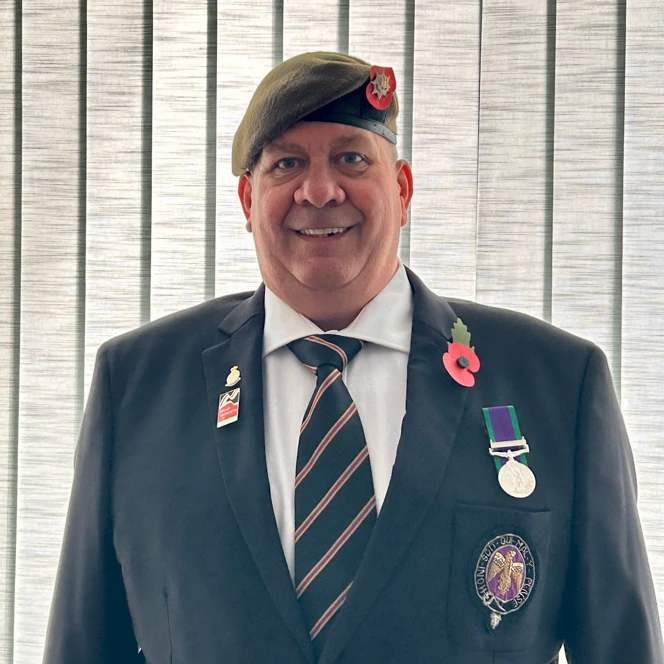 Blind veteran Mark is a navy jacket, tie, medal, and poppy