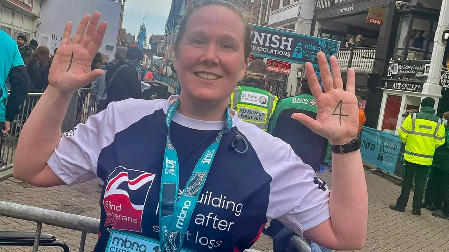Alison with a huge smile in her Blind Veterans UK vest after finishing the Chester 10k