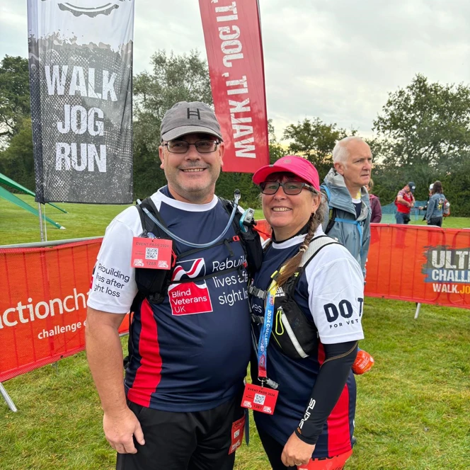 Blind veterans Andy and his wife ahead of the challenge wearing their Blind Veterans UK t-shirts, walking boots and baseball caps with big smiles on their faces.