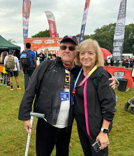 Peter and Glynis posing for a picture ahead of the start in front of the event banners