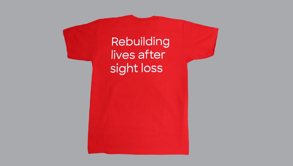 Back of t-shirt showing tagline "Rebuilding lives after sight loss"