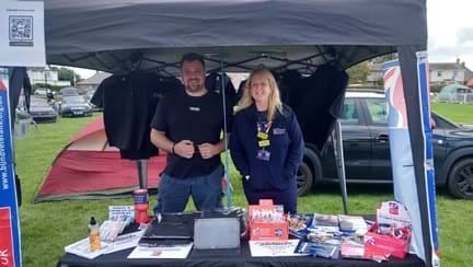 Nicola and Stevie stood next to each other at their joint information stand for the banger rally and Blind Veterans UK