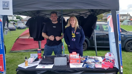 Nicola and Stevie stood next to each other at their joint information stand for the banger rally and Blind Veterans UK