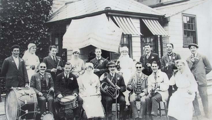 A black and white photo of the St Dunstan's Band. A group of blind veterans all with instruments such as Drums, flutes, trumpets and horns