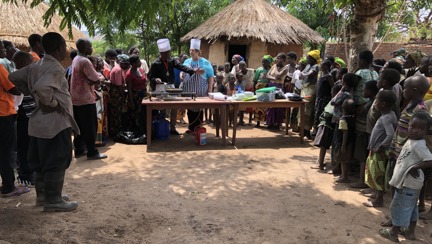 Photo of Malawian home cooks and local head chef Cephus teaching Penny, centre, authentic local cuisine