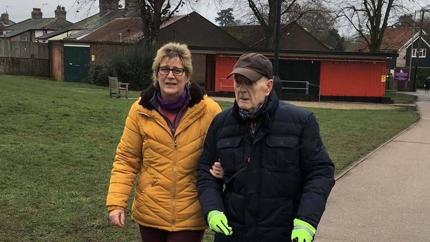 Photo of blind veteran and his daughter, walking laps to raise money for Blind Veterans UK