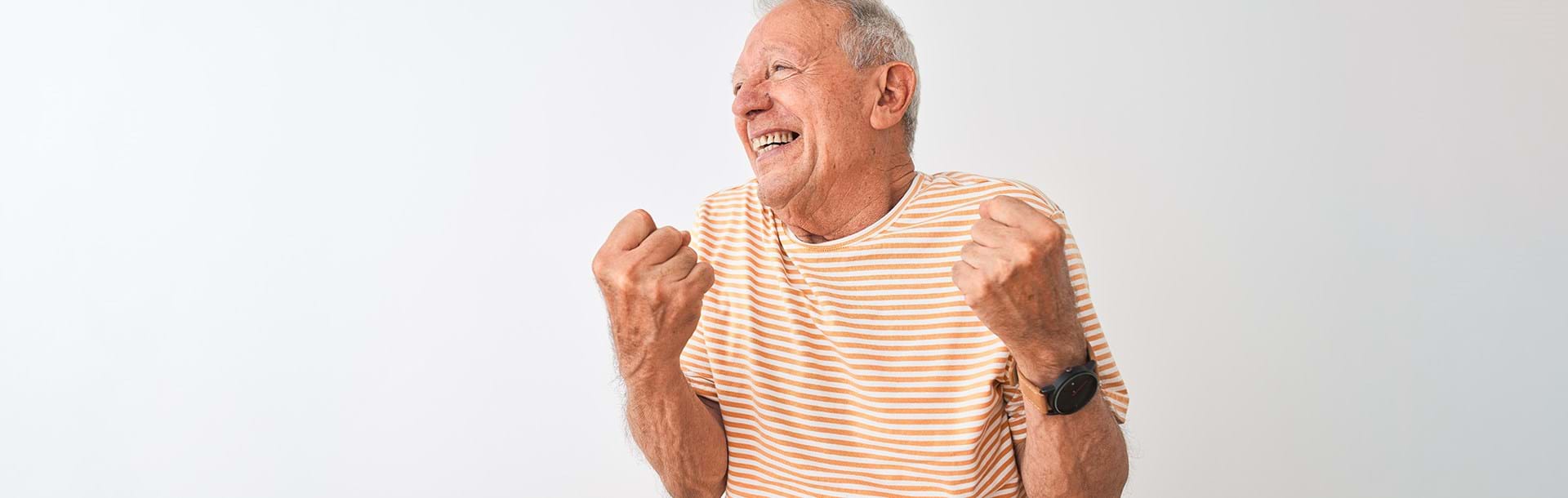 A photo of an elderly man happily cheering