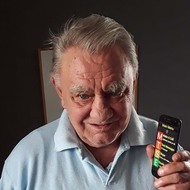 A photo of Ken Carter with his Synapptic phone