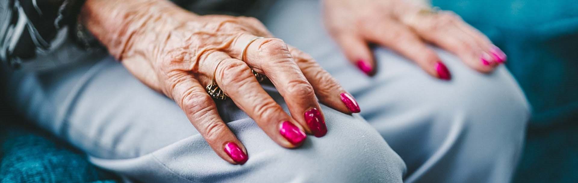 Female blind veteran's hands resting on her lap