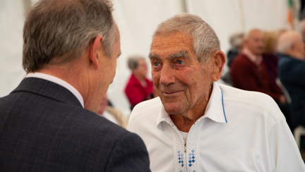 Blind veteran Eddie smiling as he listen to Nick Caplin speak