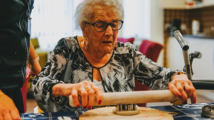 A photo of a blind veteran cooking at the Llandudno centre