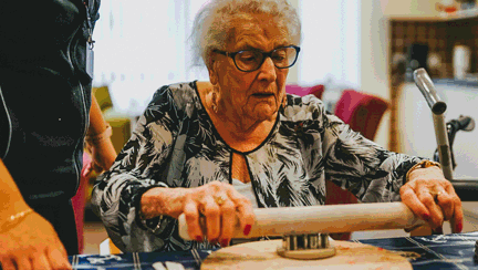 A photo of a blind veteran cooking at the Llandudno centre