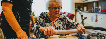 A photo of a blind veteran cooking at the Llandudno centre