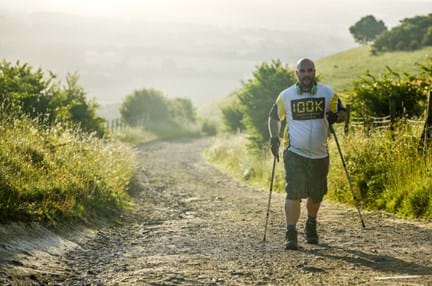 A photo of a man walking through the countryside for the 100K London To Brighton challenge
