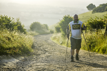 A photo of a man walking through the countryside for the 100K London To Brighton challenge