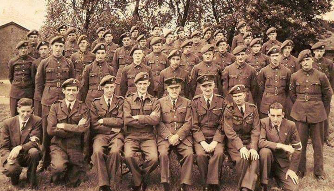 An old black and white group photograph of Ken in uniform with his squadron