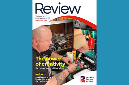 A magazine front cover with title "The power of creativity" and an image of a blind veteran using a digital magnifier to do crafts