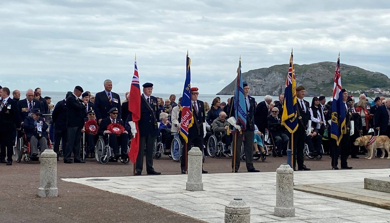 Standard bearers and veterans laying wreaths at the Llandudno war memorial