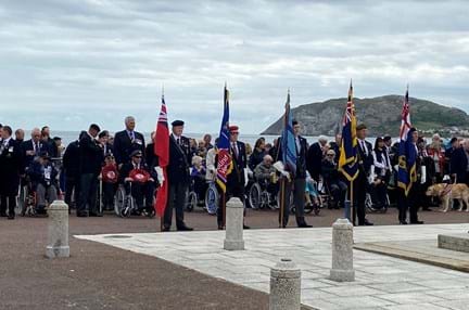 Standard bearers and veterans laying wreaths at the Llandudno war memorial