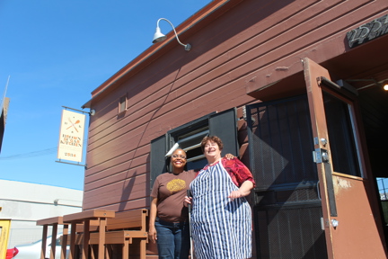 Photo of Tanya, left, showing blind Brit cook, Penny, right, the basics of her famous Creole cuisine in California