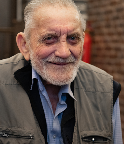 A portrait of blind veteran Ken smiling 