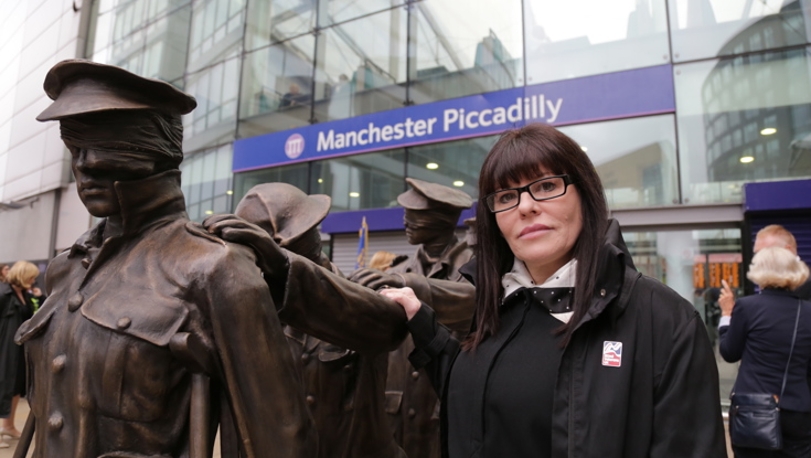 A photo of artist and sculptress Johanna Domke-Guyot standing next to her Victory Over Blindness statue