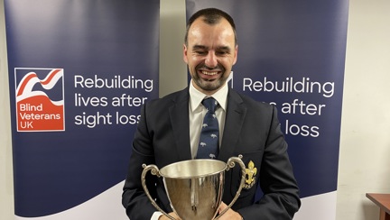 Craig Lundberg holding the Ted Higgs Trophy at the Founder's Awards 2023