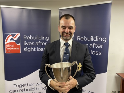 Craig Lundberg holding the Ted Higgs Trophy at the Founder's Awards 2023