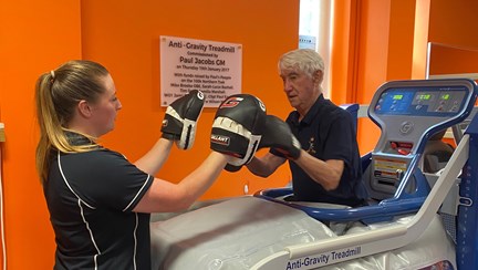 Blind veteran Stan practicing boxing on an anti-gravity treadmill.