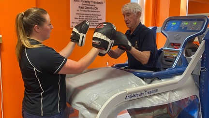 Blind veteran Stan practicing boxing on an anti-gravity treadmill.