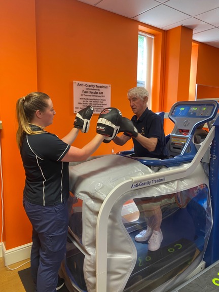 Blind veteran Stan practicing boxing on an anti-gravity treadmill.