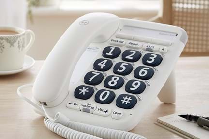 A close-up of a landline telephone with large buttons