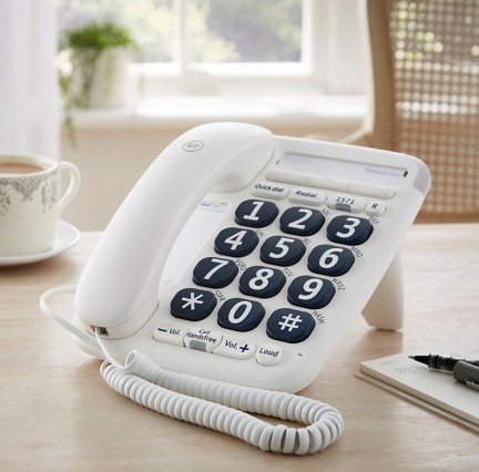 A close-up of a landline telephone with large buttons