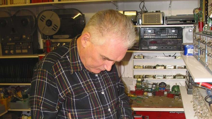 Photo of blind veteran, Terry, pictured in a workshop, building using Meccano.
