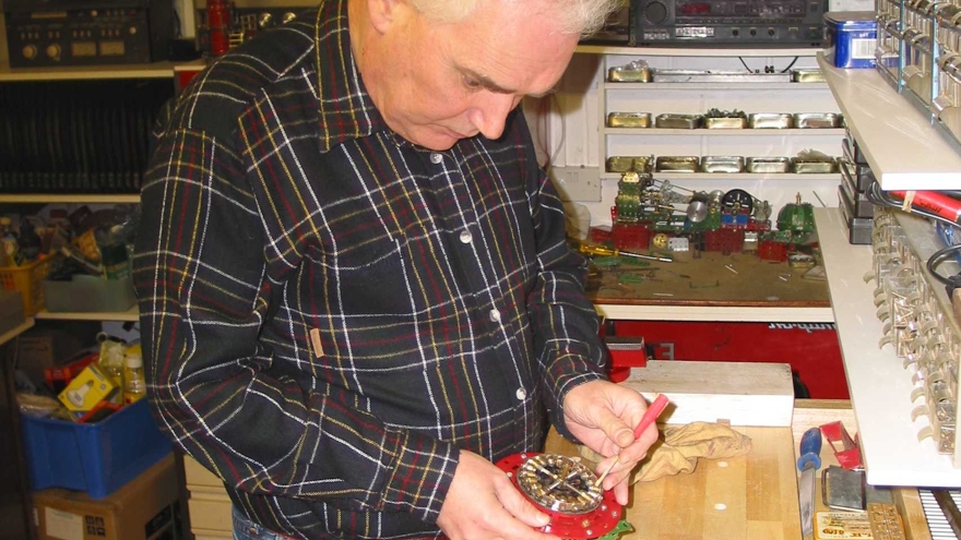 Blind veteran, Terry, pictured in his workshop, building using Meccano.