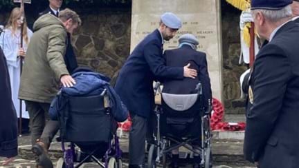 Ken and Nancy at the Rustington War Memorial, Nancy is being helped from her wheelchair by staff member.