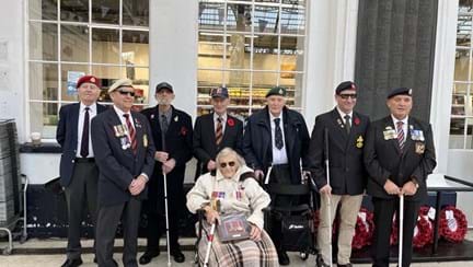 Group of eight blind veterans to the side of the War Memorial at Brighton Train Station