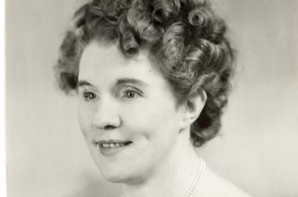 Black and white portrait photograph of Gwen Obern smiling