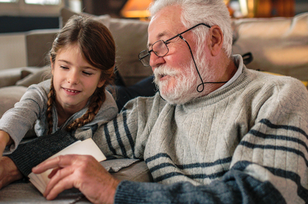 A grandad showing his granddaughter memories from past