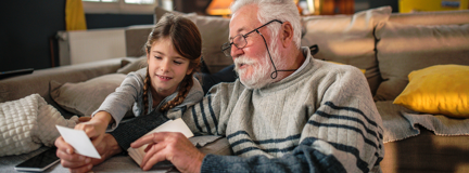 A grandad showing his granddaughter memories from past