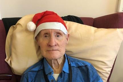 Photo of Arthur Harvey, Blind veteran, wearing Christmas hat