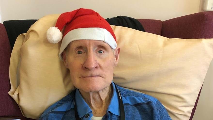 Photo of Arthur Harvey, Blind veteran, wearing Christmas hat