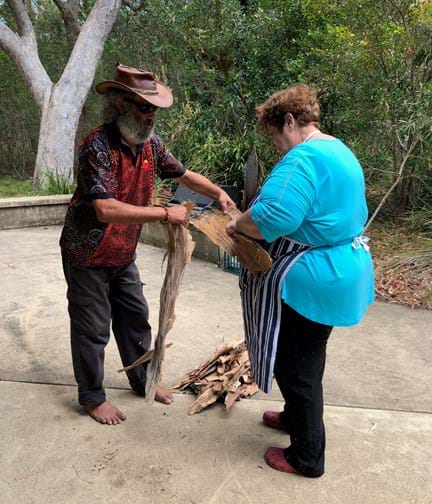 A photo of Fred, left, teaching Penny, right, about Bush Tucker in Australia