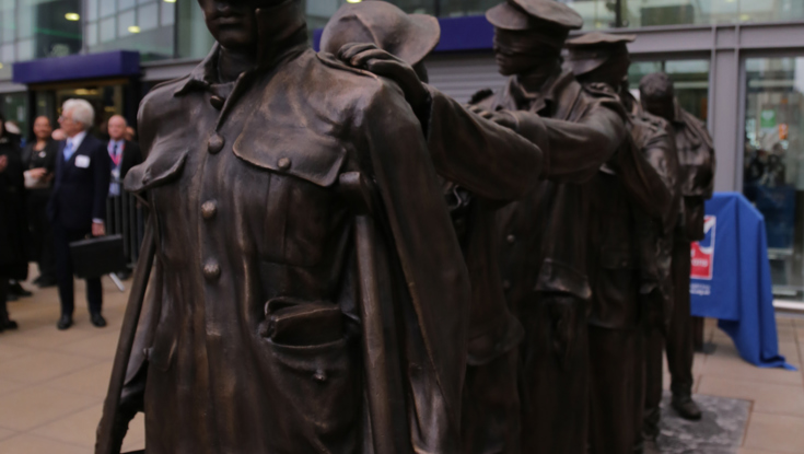 Victory Over Blindness statue depicting seven blinded soldiers leading one another with their hands on their comrades’ shoulders