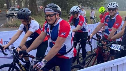Thea team members in their branded Blind Veterans UK cycling tops, on their bikes at the London to Brighton start line.