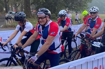 Thea team members in their branded Blind Veterans UK cycling tops, on their bikes at the London to Brighton start line.