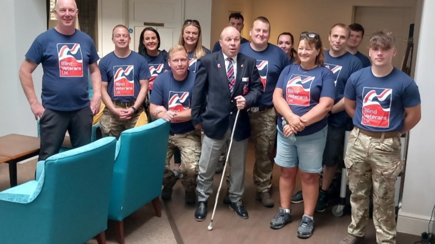 A group photo of the walkers wearing their charity t-shirts inside the centre with Billy