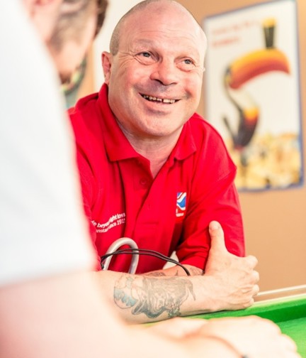 Portrait of blind veteran Billy, resting arms against a table