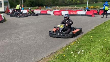 Chris driving around a track in a go-kart