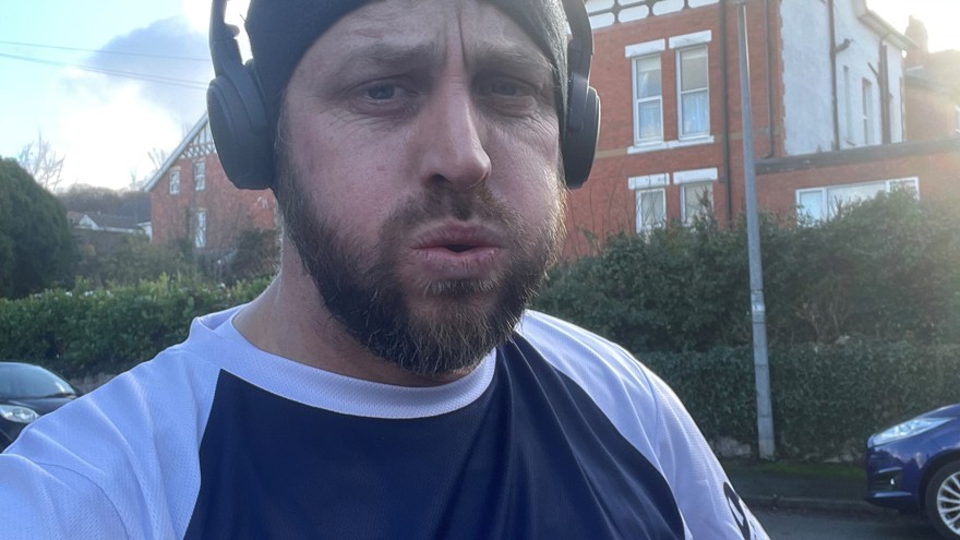 Matt at the end of a training run wearing a Blind Veterans UK t shirt